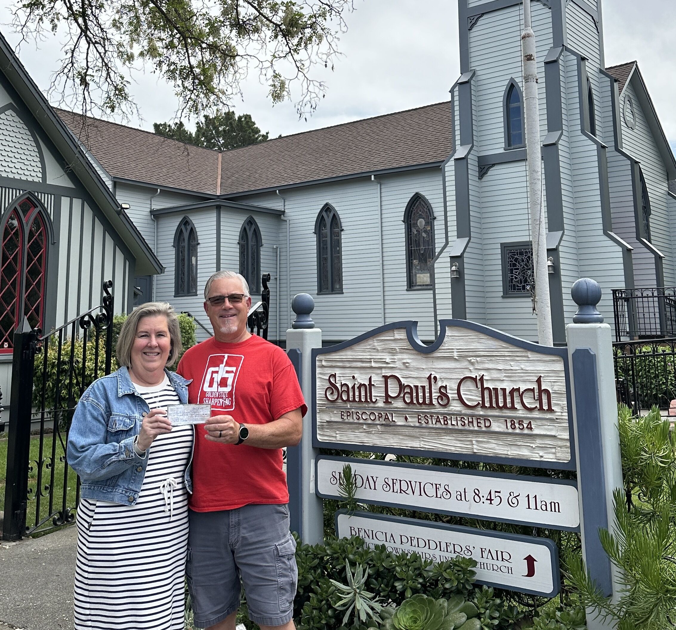Golden State Sharpening presents fundraiser check to St. Paul's Community Meal Program in front of St. Paul's of Benicia